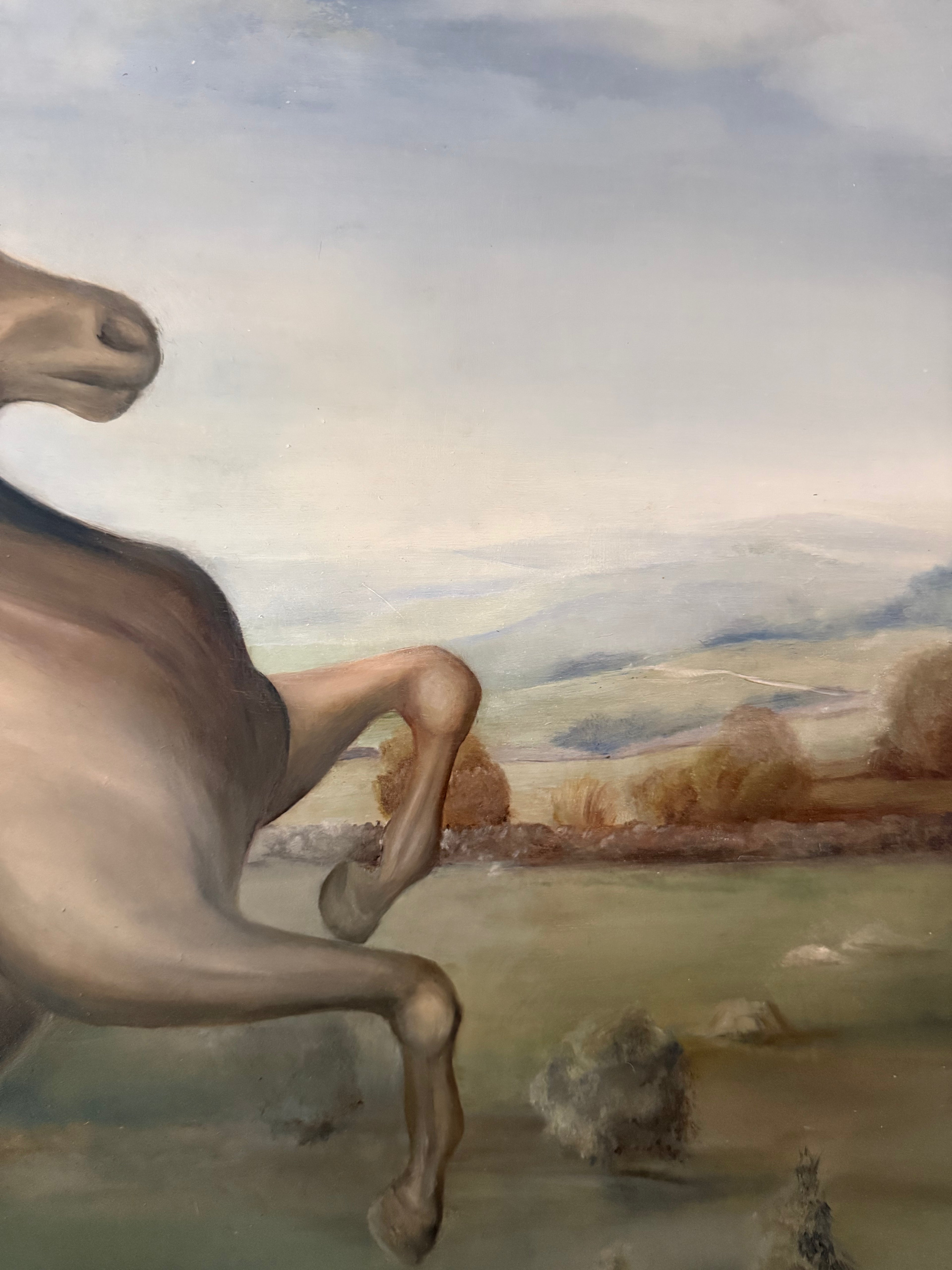 Horse rearing in a landscape with mountains and trees