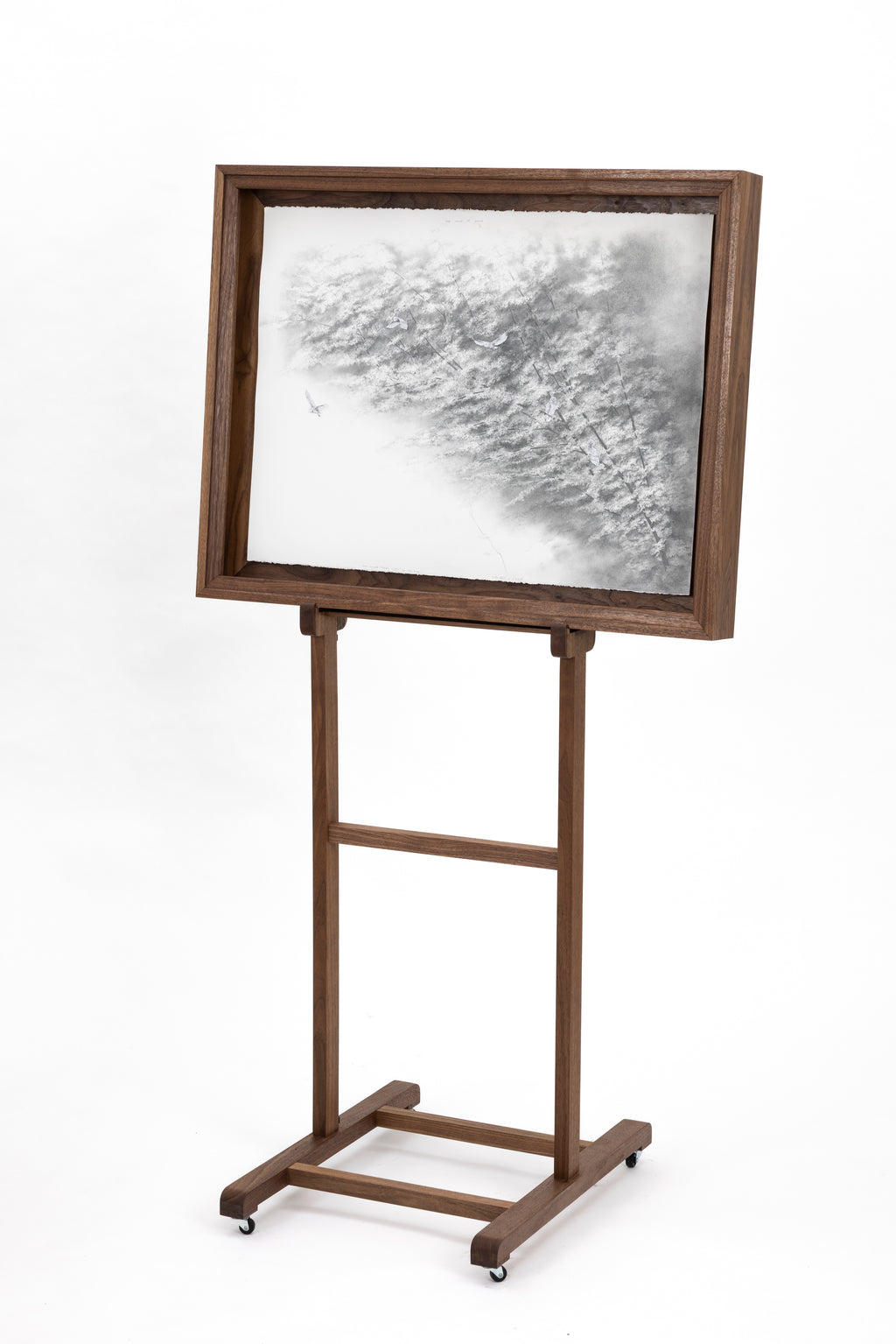 Wooden easel with a framed artwork on a white background